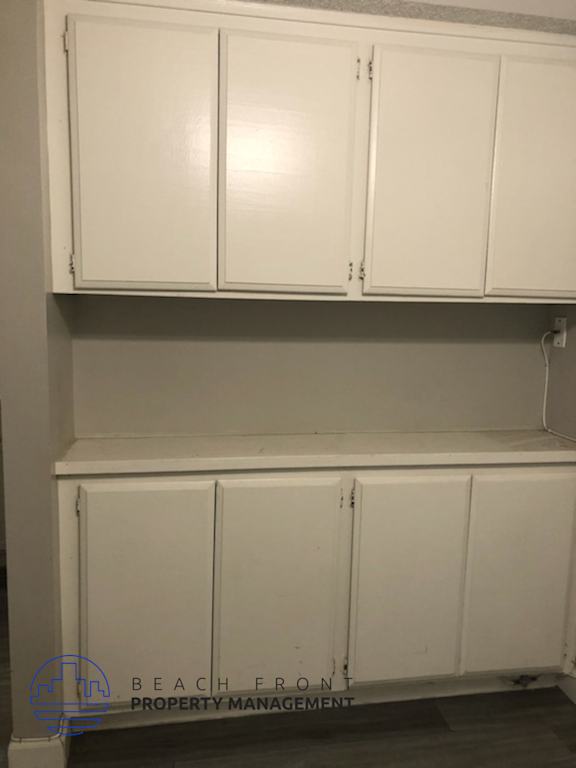 A white cabinet with a logo of Beach Front Property Management.