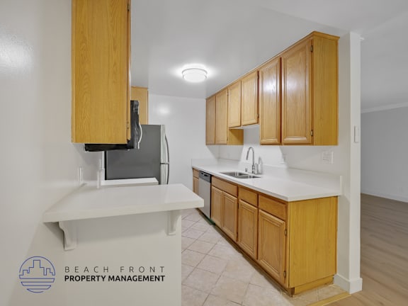 A kitchen with wooden cabinets and a white countertop.