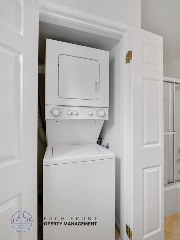 A white oven is built into a white cabinet in a white room.