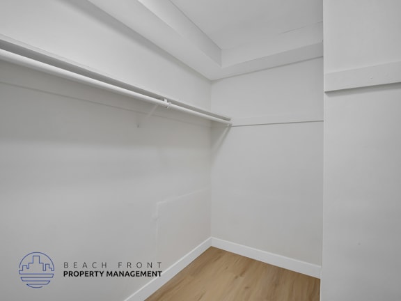 A white wall with a logo that says "Beach Front Property Management".