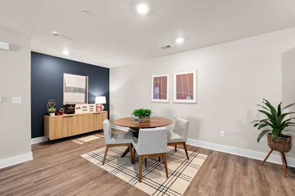 a dining room with a wooden table and chairs and a couch