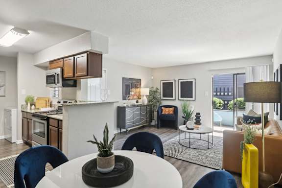 A modern kitchen with a dining table and chairs.