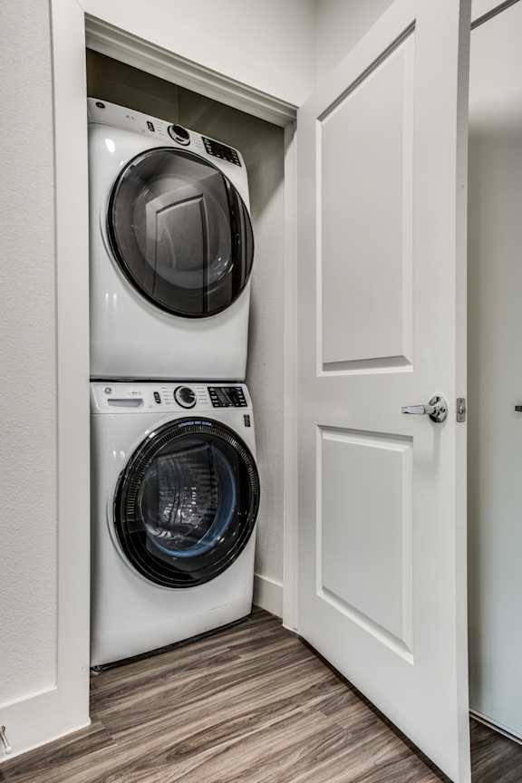 A white washing machine and dryer in a small laundry room.