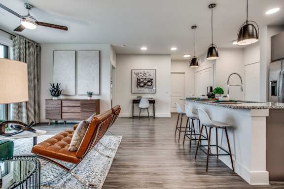 A modern kitchen with a bar area and a dining table.