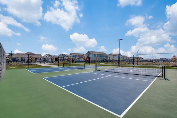 A tennis court with a blue surface and white lines.