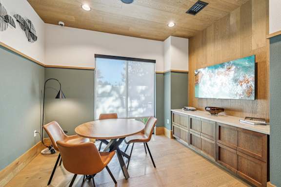 A conference room with a table and chairs.