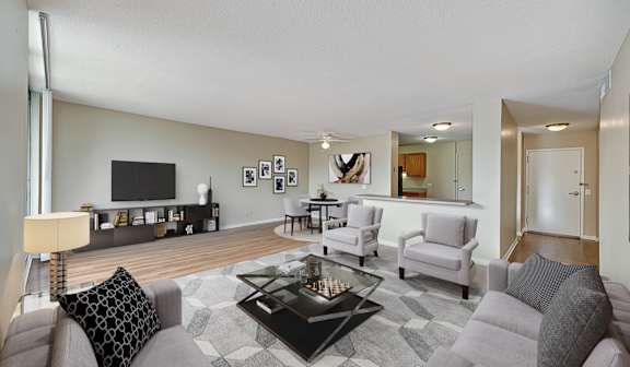 A living room with a grey couch and a black coffee table.