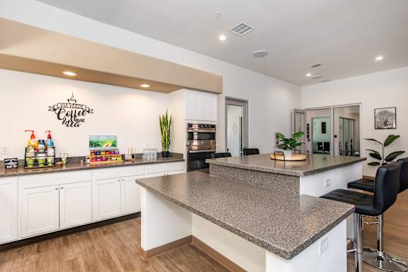 A kitchen with a granite countertop and white cabinets.