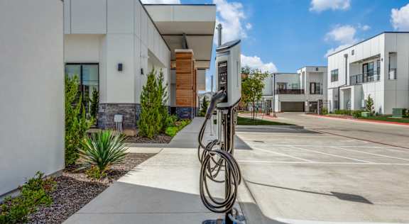 A modern building with a sculpture in front of it.