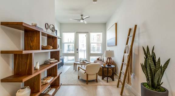 A living room with a white ceiling and a fan.