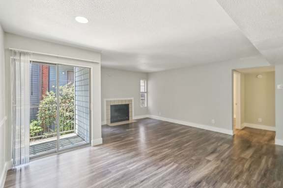 A spacious living room with a fireplace and sliding glass doors.