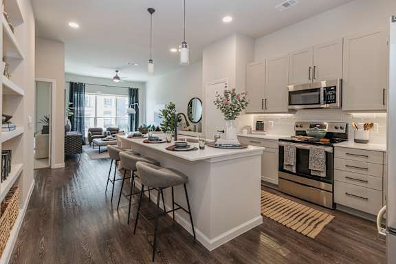 A modern kitchen with white cabinets and a large island.