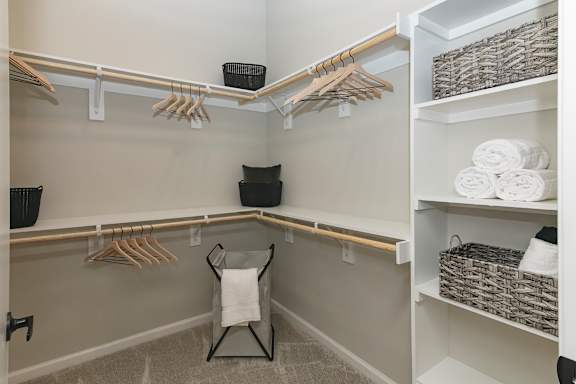 A bathroom with a white chair and towels.