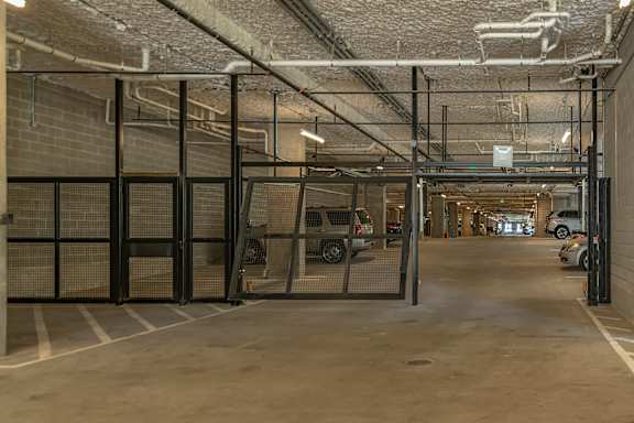 A parking garage with a car parked in the distance.