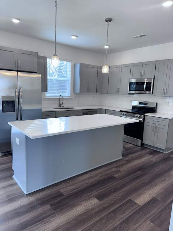 A modern kitchen with a large island in the center.