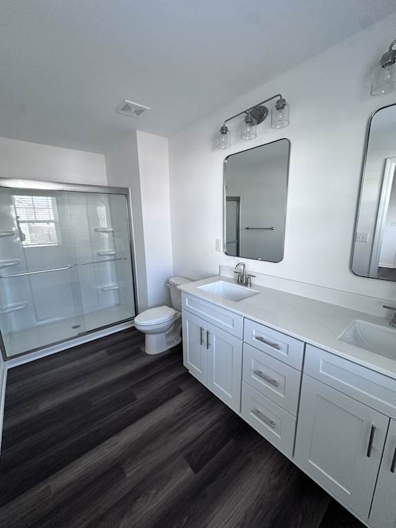 A bathroom with a white toilet, sink, and mirror.