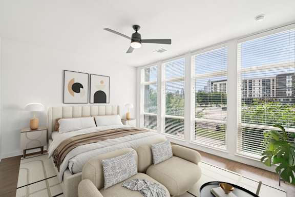 A bedroom with a large bed and a couch.