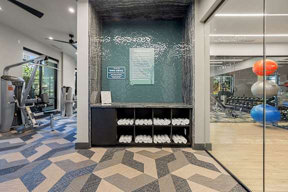A gym with a variety of equipment and a sign on the wall.