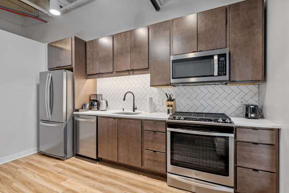 A kitchen with wooden cabinets and stainless steel appliances.