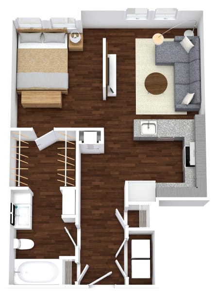 A top-down view of a small apartment with a bed, a couch, a chair, a table, and a kitchenette.