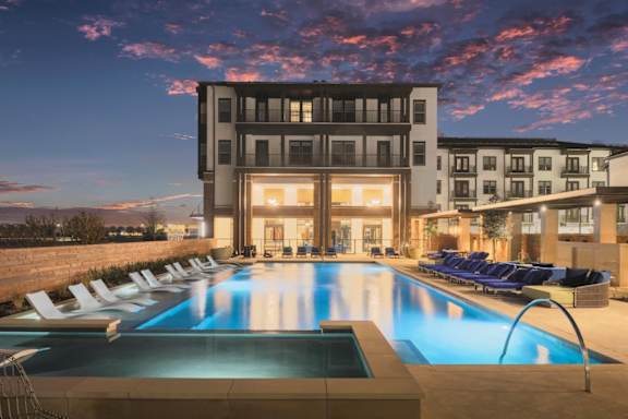 A large swimming pool in front of a modern building.