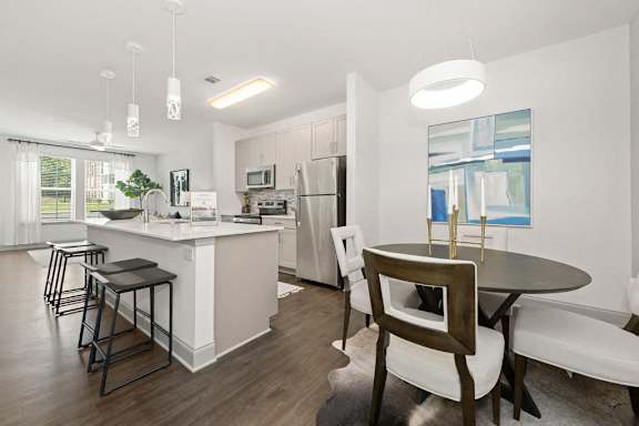 a kitchen and dining area with a table and chairs