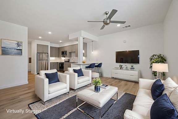 A living room with a white couch and a coffee table.