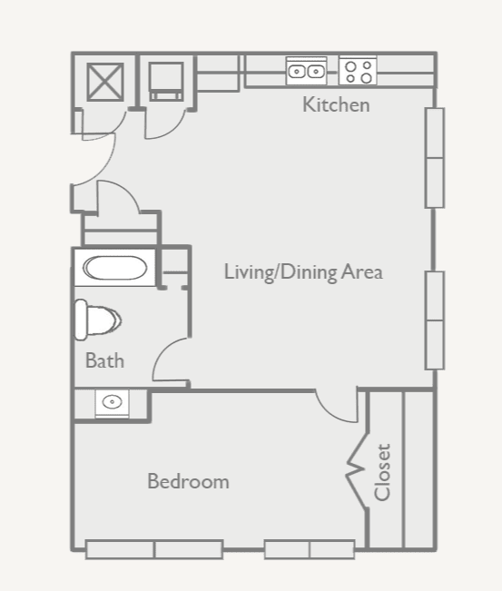 A floor plan of a small apartment with a kitchen, living/dining area, bathroom, and bedroom.