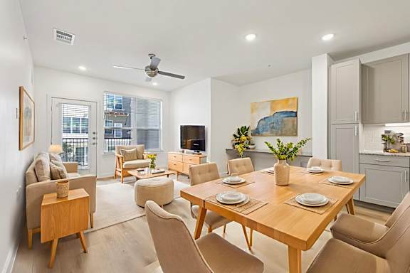 A modern dining room with a wooden table and chairs.