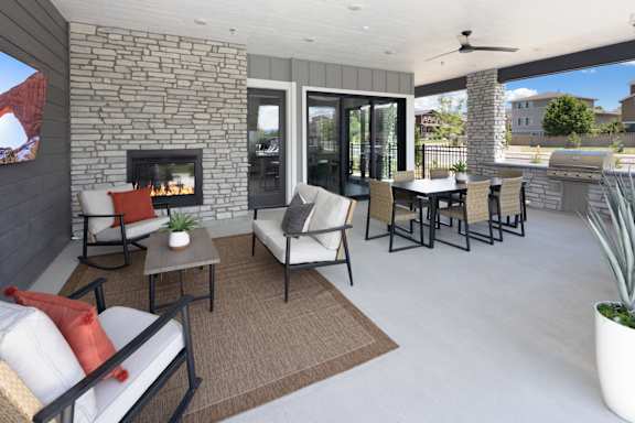 A patio with a fireplace and furniture.