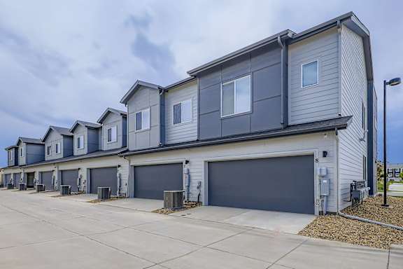 A row of houses with garages in front.