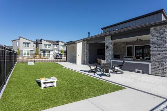 A backyard with a lawn and a patio area.