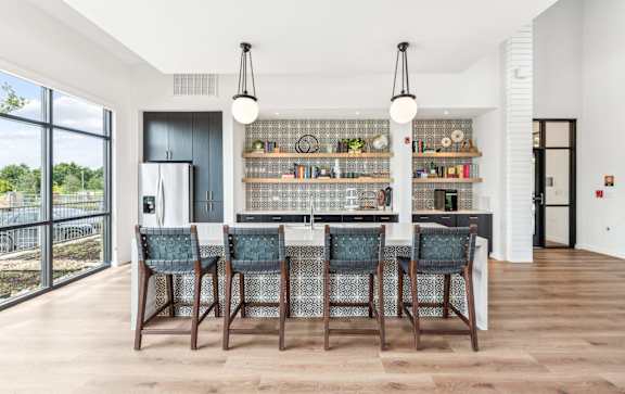 A modern kitchen with a dining table and chairs.