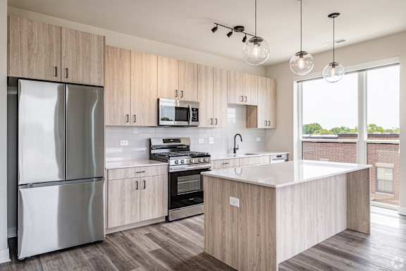 A modern kitchen with wooden cabinets and stainless steel appliances.
