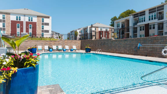 a swimming pool at a apartments complex with a blue pool