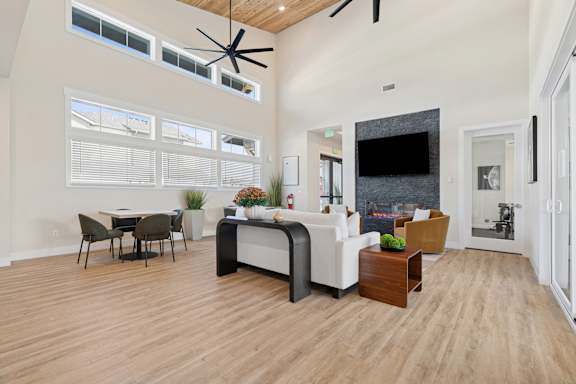 A modern living room with a dining table and a fireplace.