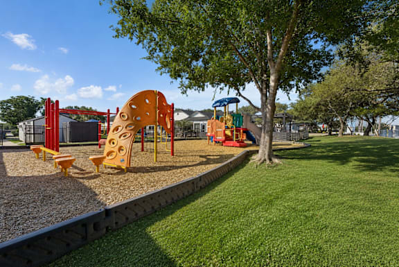 A playground with a slide, swings, and a climbing frame.