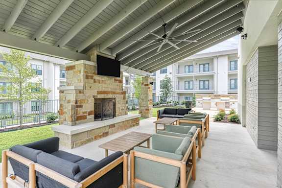A patio with a fireplace and seating area.