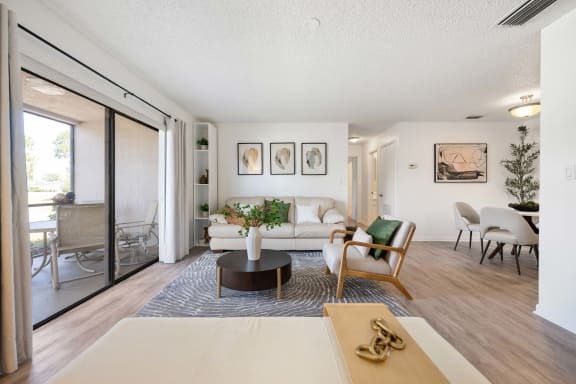 a living room with a white couch and a sliding glass door