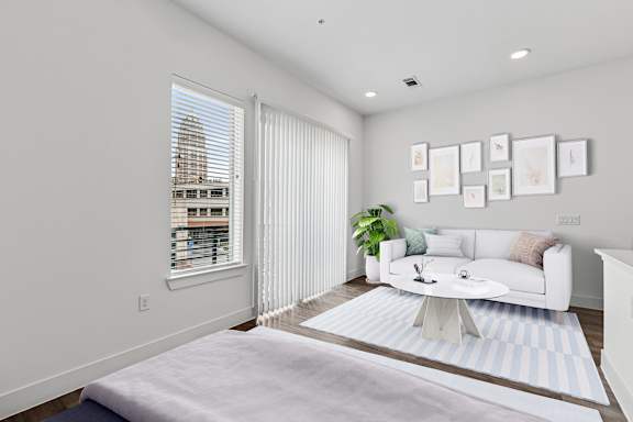 A living room with a white couch and a coffee table.