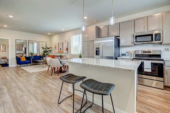A kitchen with a bar area and stools.