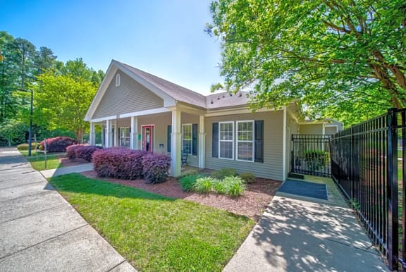 a small house with a yard and a sidewalk