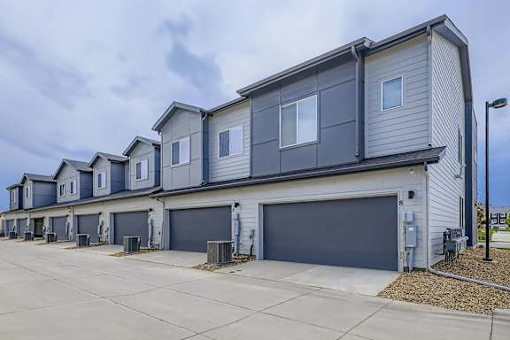 A row of houses with garages in front.