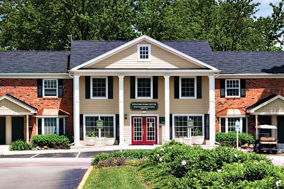 A building with a red door and a sign that says "Welcome to Riverside".