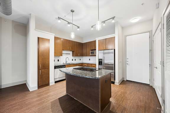 A kitchen with wooden cabinets and a central island.