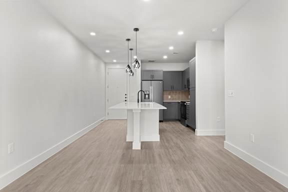 A kitchen with a white island in the middle of the room.
