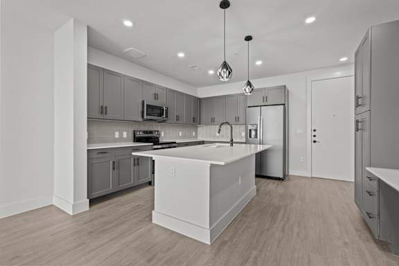 A modern kitchen with a large island in the center.