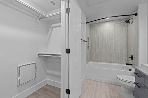 A white bathroom with a toilet, sink, and bathtub.