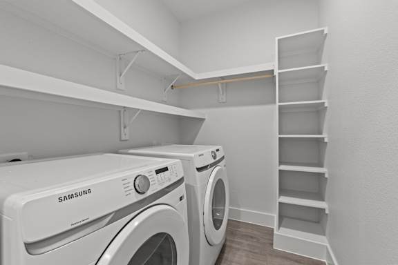 A white Samsung washing machine in a laundry room.