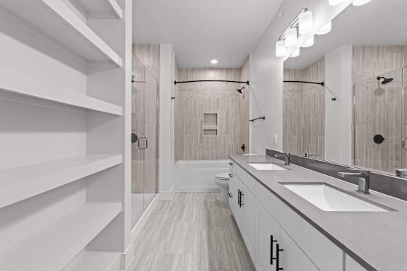 A bathroom with a white sink and a white toilet.